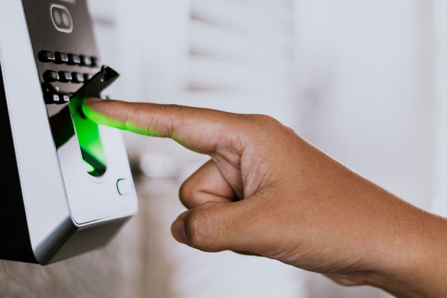 Photography of a person putting his or her finger in an access control device