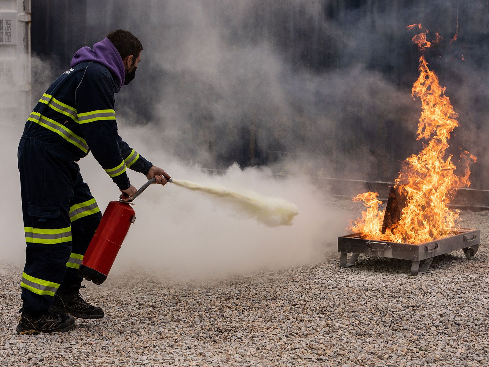 Person with fire extinguisher equipment during a training session in Apagafoc Ibiza